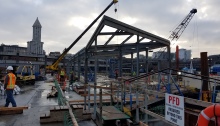 A westward-facing image at King County Water Taxi's future Passenger Only Ferry (POF) facility. With completion of the shelter's structural frame - show being built in this picture - it marks the first time work on the facility has gone vertical.