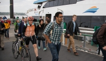 A group of riders from Vashon Island - including a bicylist - disembark the MV Sally Fox after it arrives at Pier 52 on the Seattle waterfront.