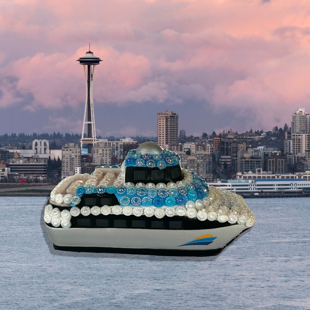 A squishy water taxi toy with sparkly jewels glued to it imposed on a Seattle skyline backdrop with the Space Needle.